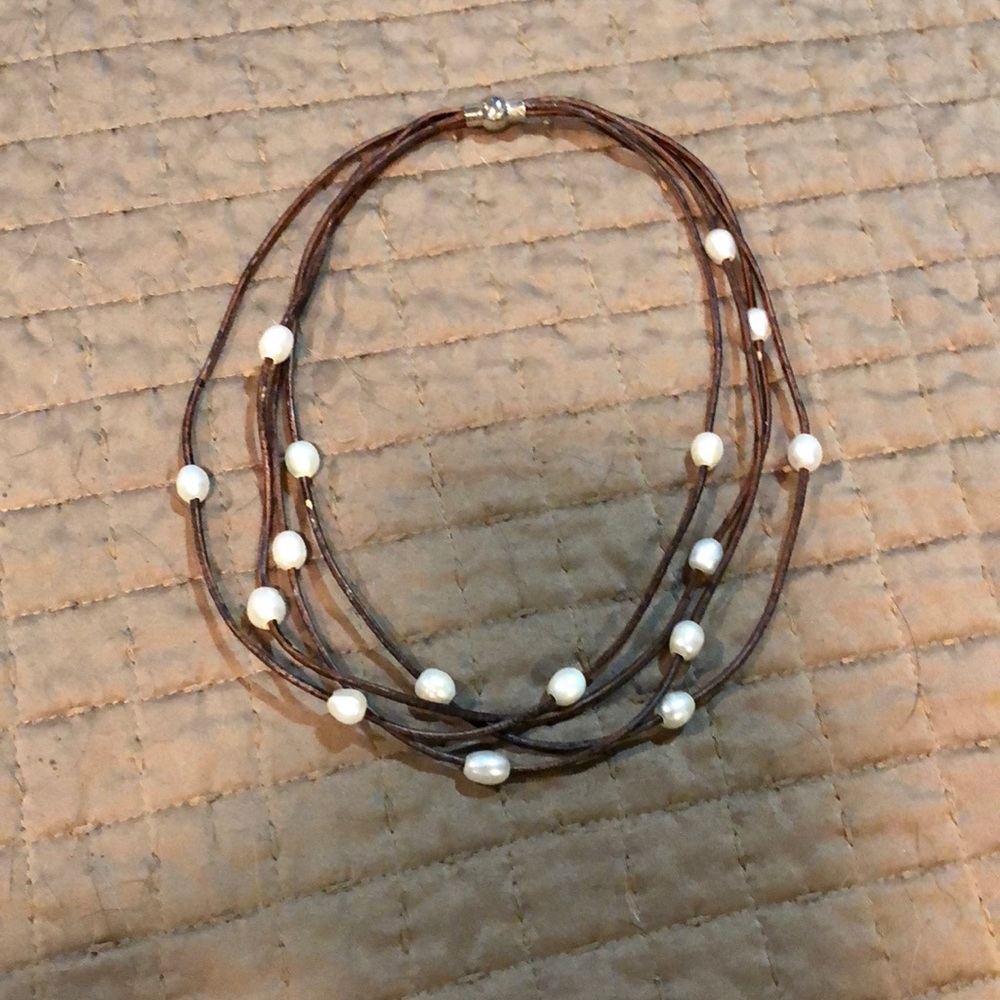 Multi strand pearl necklace with leather band.
